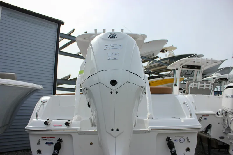 Slide: The Image of 2026 Sea Hunt Ultra 235 SE boat with Yamaha 250 V6 engine, docked outdoors. - 9