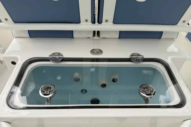 Slide: The Image of Livewell on 2026 Ranger 2660 Bay boat, featuring blue seating and stainless steel fixtures. - 3