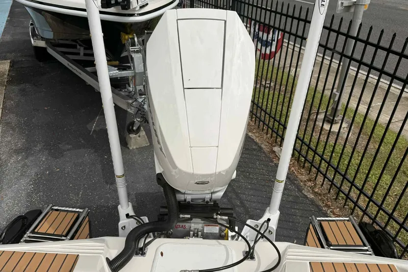 Slide: The Image of 2026 Ranger 2660 Bay boat with outboard motor, parked on a trailer. - 7