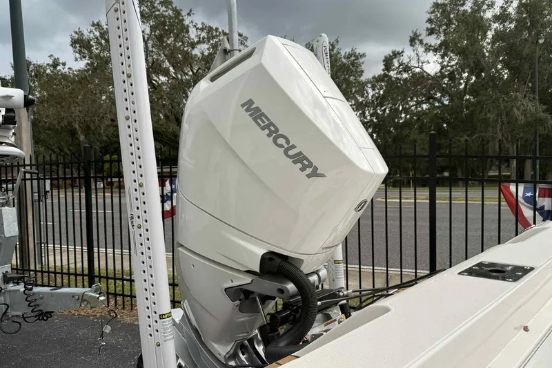 Slide: The Image of 2026 Ranger 2660 Bay boat with Mercury outboard motor, parked outdoors. - 9