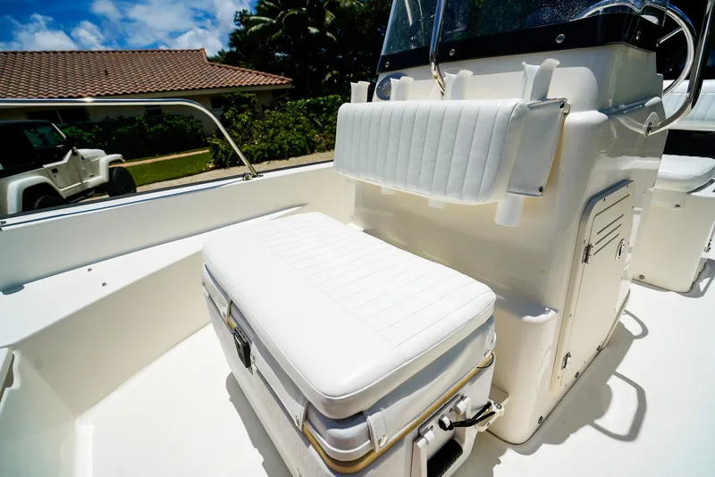 Slide: The Image of 2016 Boston Whaler 170 Montauk boat interior with white seating and console. - 14