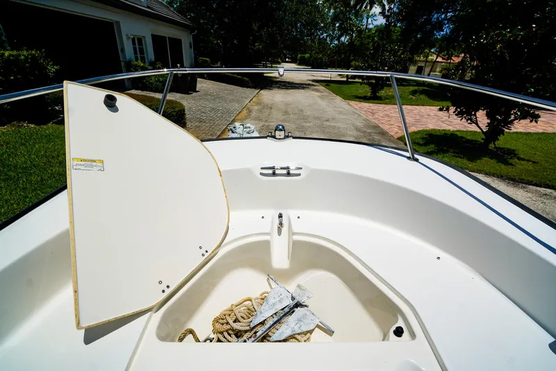 Slide: The Image of 2016 Boston Whaler 170 Montauk boat with open storage compartment and anchor. - 15