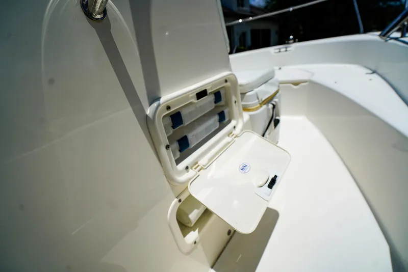Slide: The Image of 2016 Boston Whaler 170 Montauk boat interior with open storage compartment. - 17