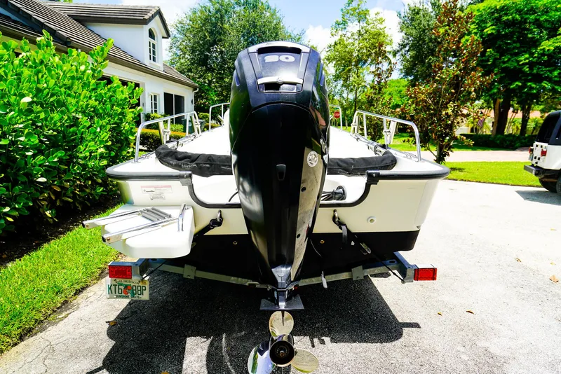 Slide: The Image of 2016 Boston Whaler 170 Montauk boat with outboard motor, parked in a driveway. - 20