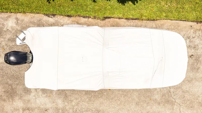 Slide: The Image of Covered 2016 Boston Whaler 170 Montauk boat on driveway, aerial view. - 24