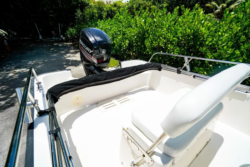 Slide: The Image of 2016 Boston Whaler 170 Montauk boat with Mercury engine, surrounded by lush greenery. - 5