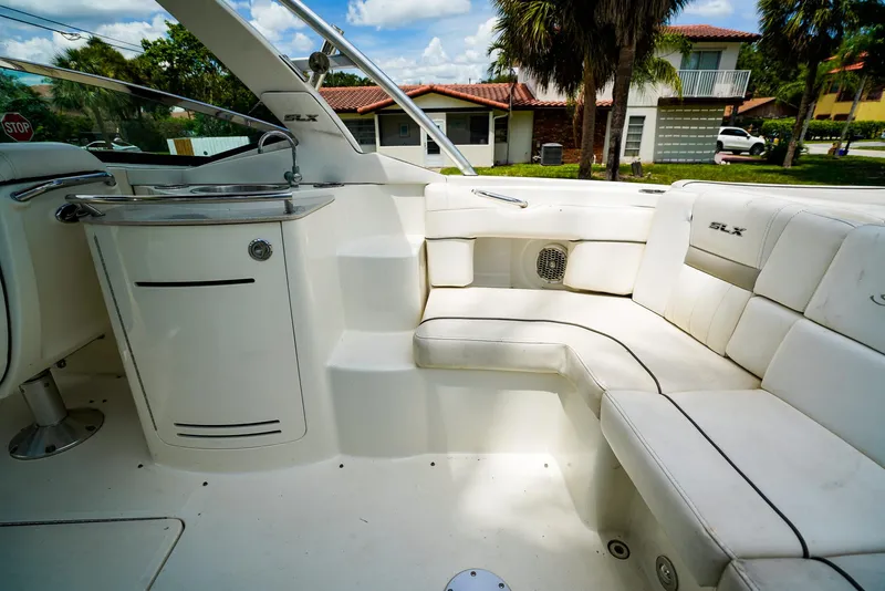 Slide: The Image of 2010 Sea Ray 270 SLX boat interior with white seating and built-in sink. - 13