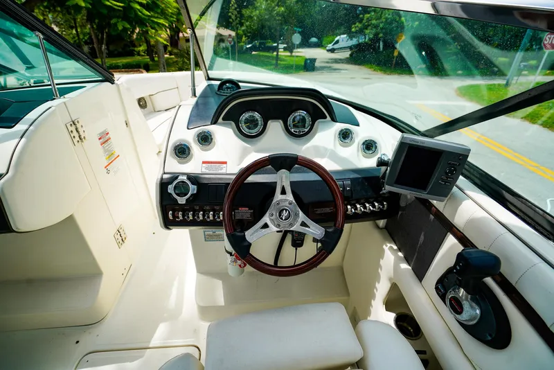 Slide: The Image of Interior view of 2010 Sea Ray 270 SLX boat cockpit with steering wheel and controls. - 18