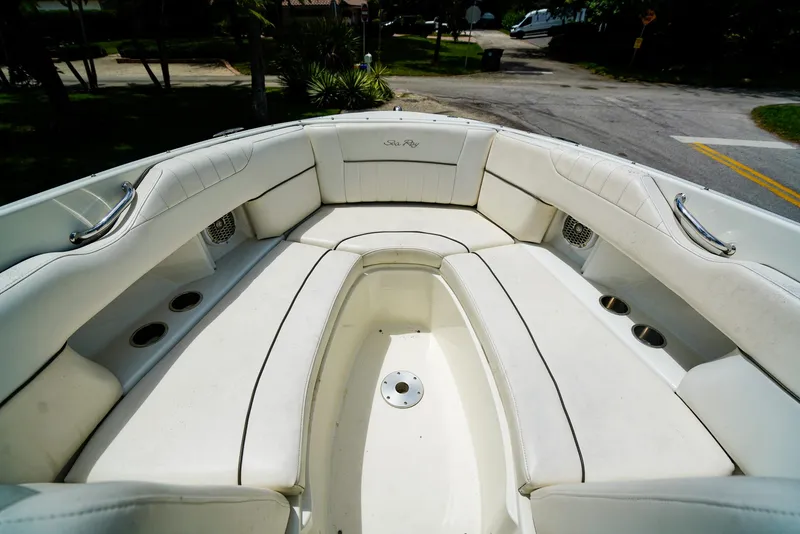 Slide: The Image of 2010 Sea Ray 270 SLX boat interior with white cushioned seating and cup holders. - 22