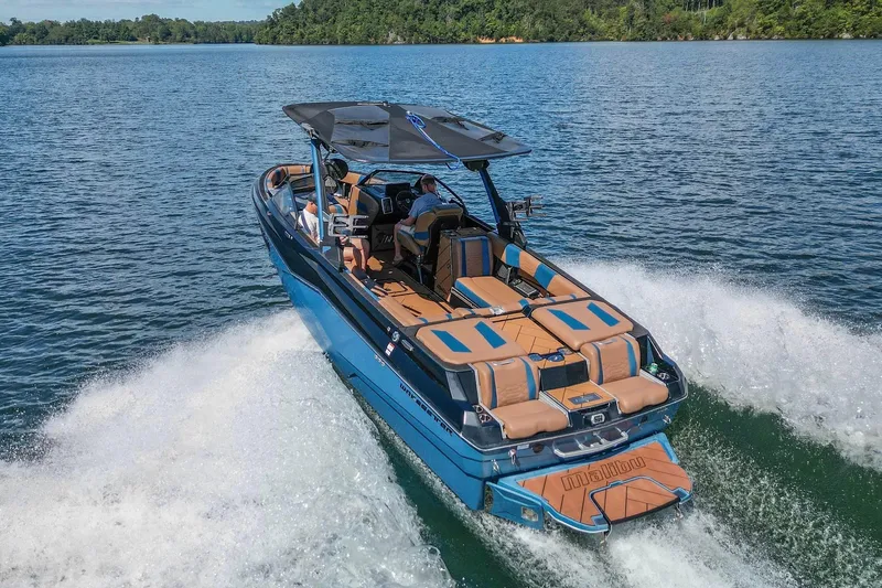 Slide: The Image of 2022 Malibu Wakesetter 25 LSV cruising on a scenic lake. - 12
