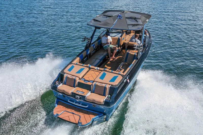 Slide: The Image of 2022 Malibu Wakesetter 25 LSV cruising on open water, showcasing luxury and performance. - 6