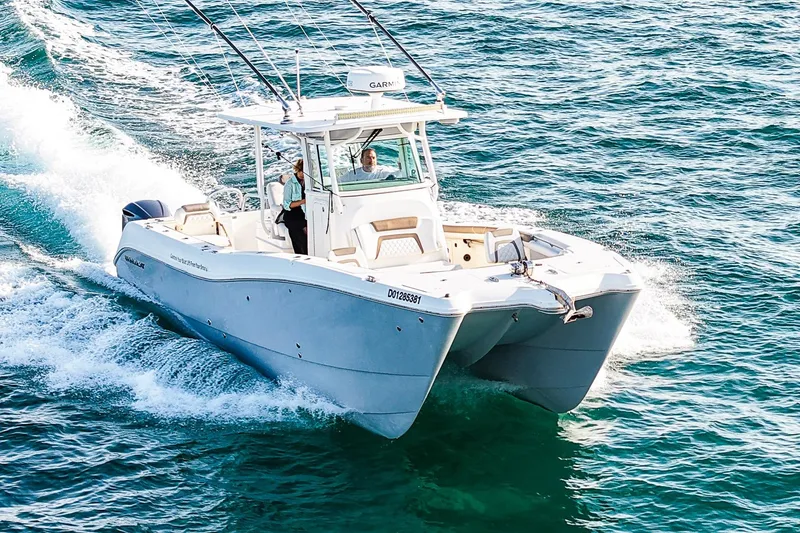 Slide: The Image of 2018 World Cat 320 CC cruising on open water, showcasing sleek design and performance. - 2