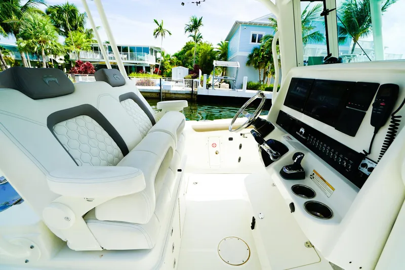 Slide: The Image of Luxurious interior of 2018 World Cat 320 CC boat with modern controls and seating. - 22