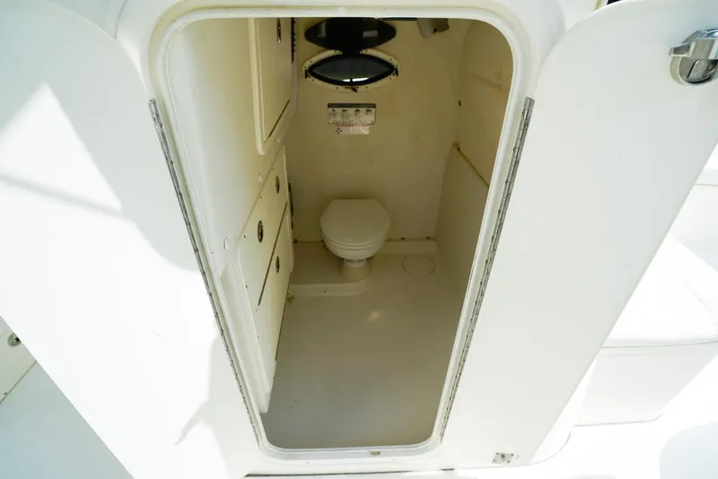 Slide: The Image of 2018 World Cat 320 CC boat interior with compact marine toilet. - 27
