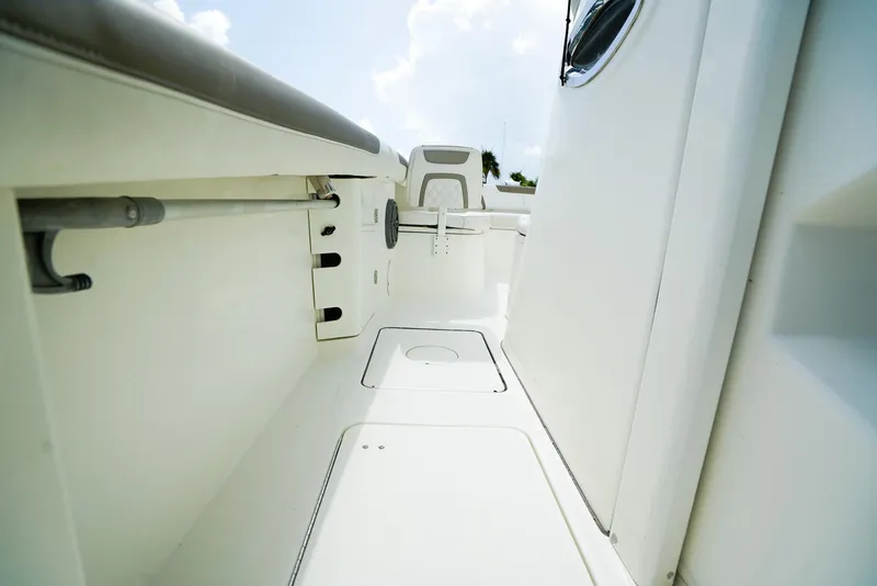 Slide: The Image of 2018 World Cat 320 CC boat interior, featuring sleek white design and spacious layout. - 29