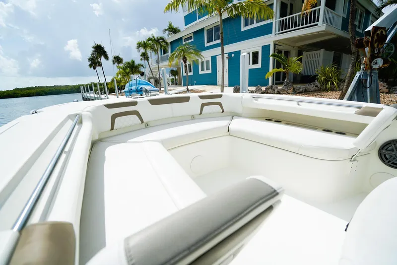 Slide: The Image of 2018 World Cat 320 CC boat interior near waterfront home and palm trees. - 35