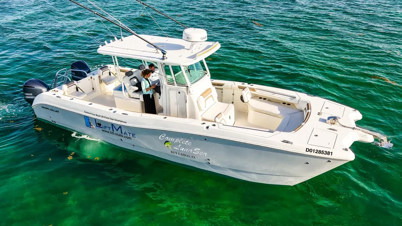 Slide: The Image of 2018 World Cat 320 CC boat on clear blue water, featuring dual engines and spacious deck. - 39