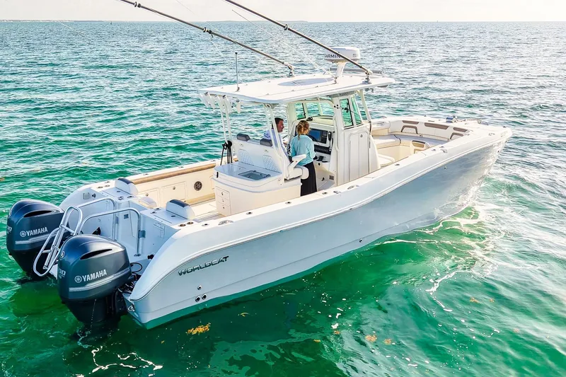 Slide: The Image of 2018 World Cat 320 CC boat on clear ocean water with dual Yamaha engines. - 41