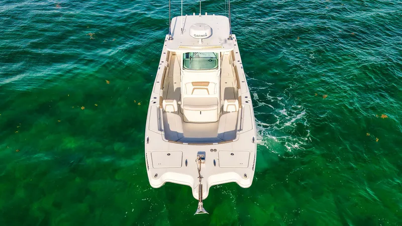 Slide: The Image of Aerial view of 2018 World Cat 320 CC boat on clear green water. - 42