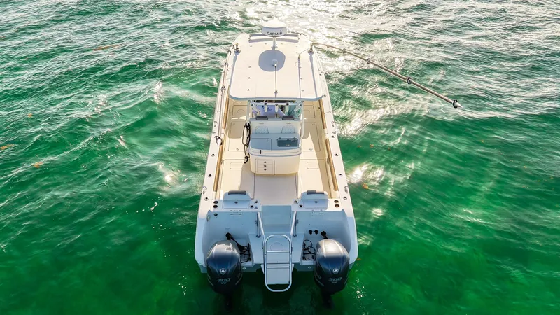 Slide: The Image of 2018 World Cat 320 CC boat on clear green water, viewed from above. - 43