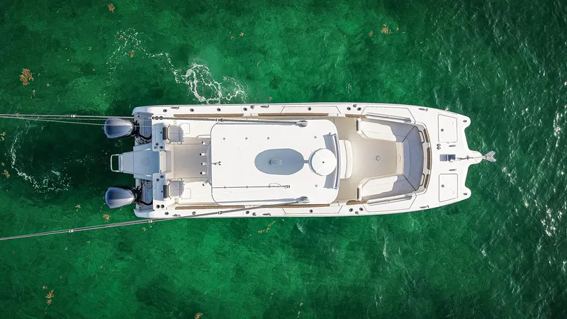 Slide: The Image of Aerial view of 2018 World Cat 320 CC boat on clear green water. - 6