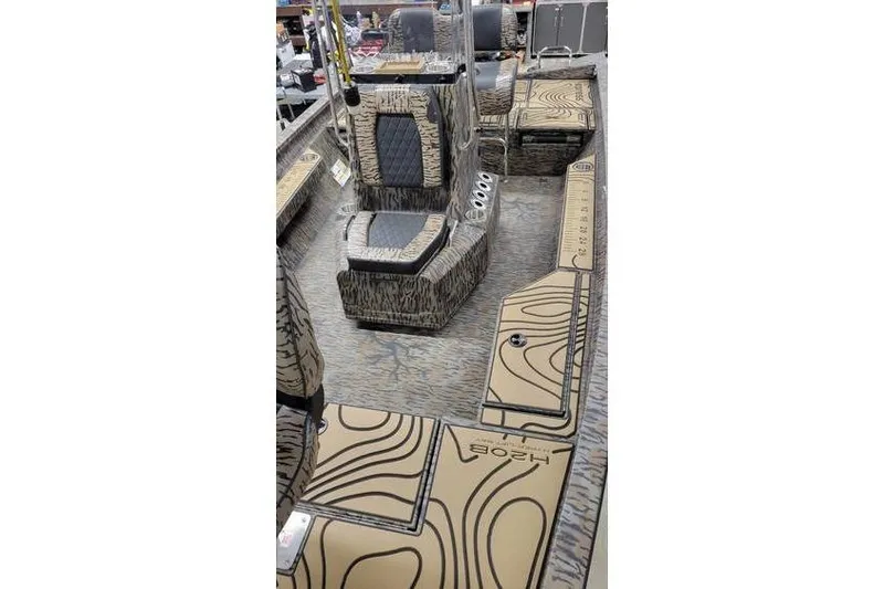 Slide: The Image of 2026 Xpress H20B Bay boat interior with patterned seating and deck design. - 13