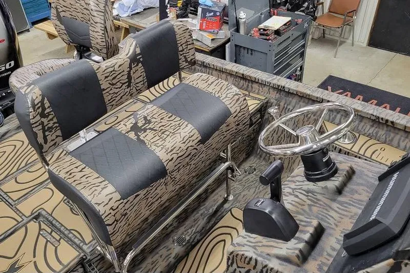 Slide: The Image of 2026 Xpress H20B Bay boat interior with patterned seats and steering wheel. - 16