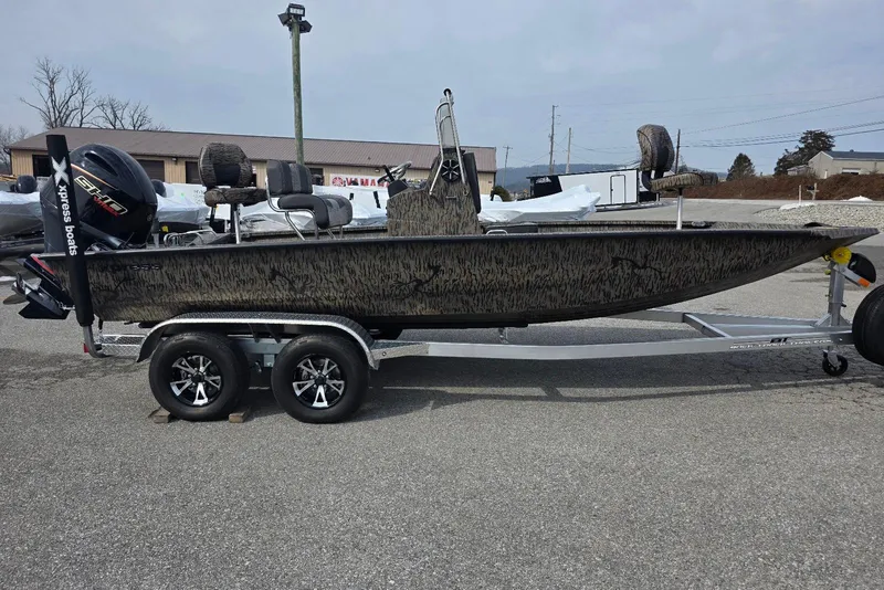The Image of 2026 Xpress H20B Bay boat on trailer, parked outdoors. - 23