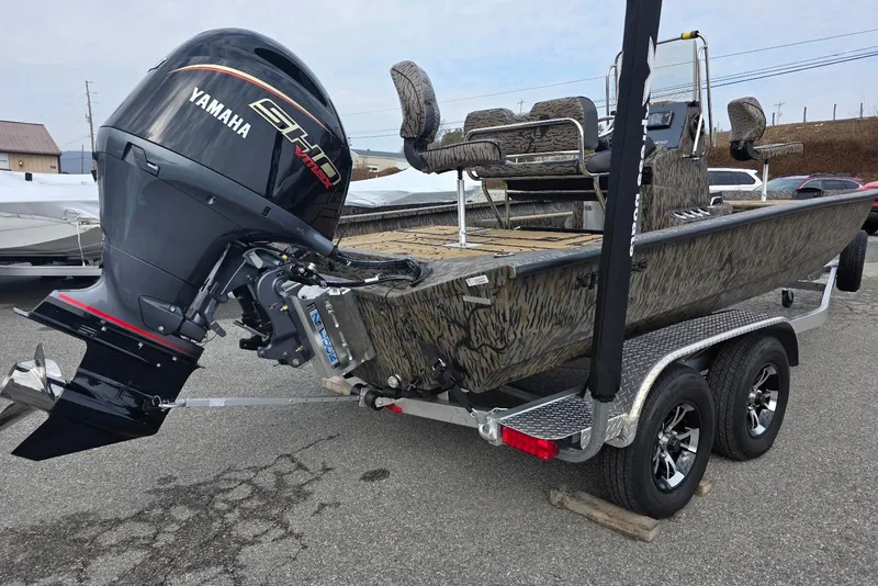 Slide: The Image of 2026 Xpress H20B Bay boat with Yamaha engine on a trailer. - 25