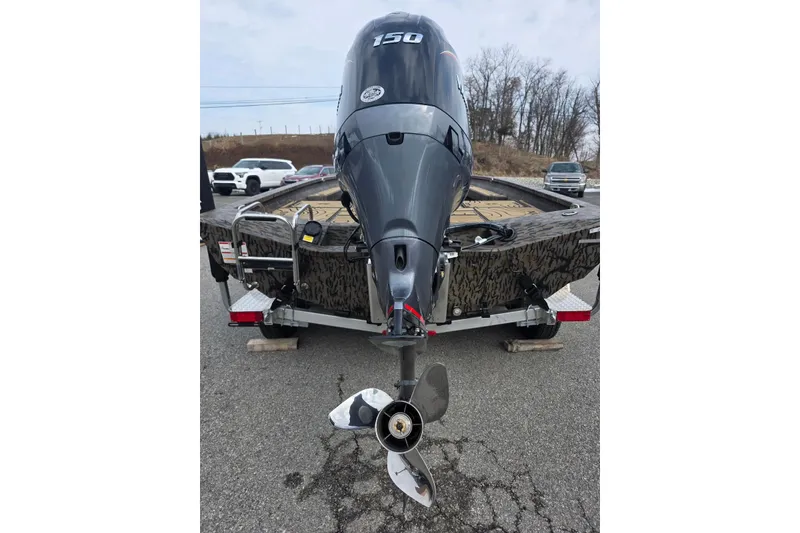 Slide: The Image of 2026 Xpress H20B Bay boat with powerful outboard motor on trailer. - 27