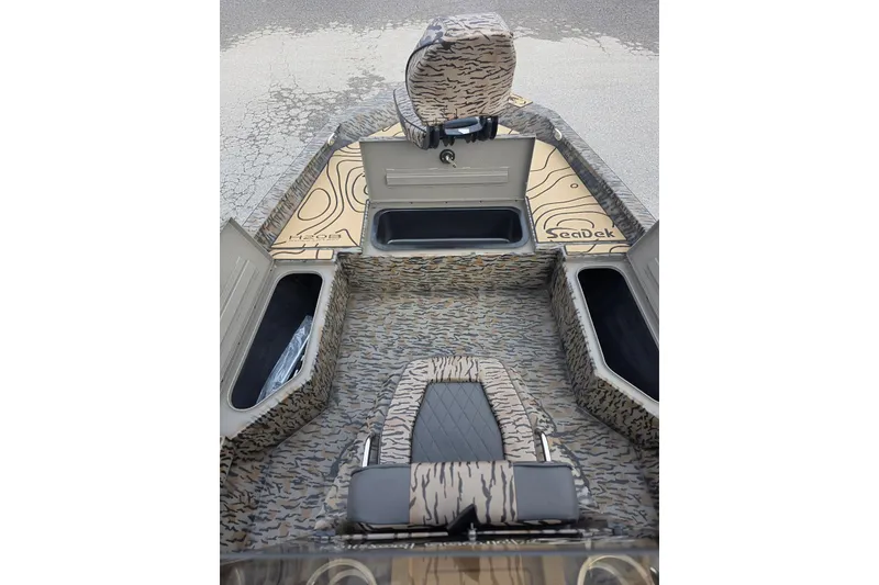 Slide: The Image of 2026 Xpress H20B Bay boat interior with SeaDek flooring and storage compartments. - 31