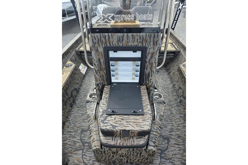 Slide: The Image of 2026 Xpress H20B Bay boat interior with camouflage design and storage compartment. - 38