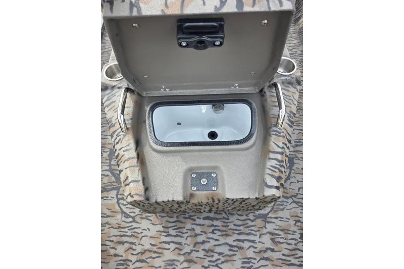 Slide: The Image of Open storage compartment in 2026 Xpress H20B Bay boat with camouflage pattern. - 39