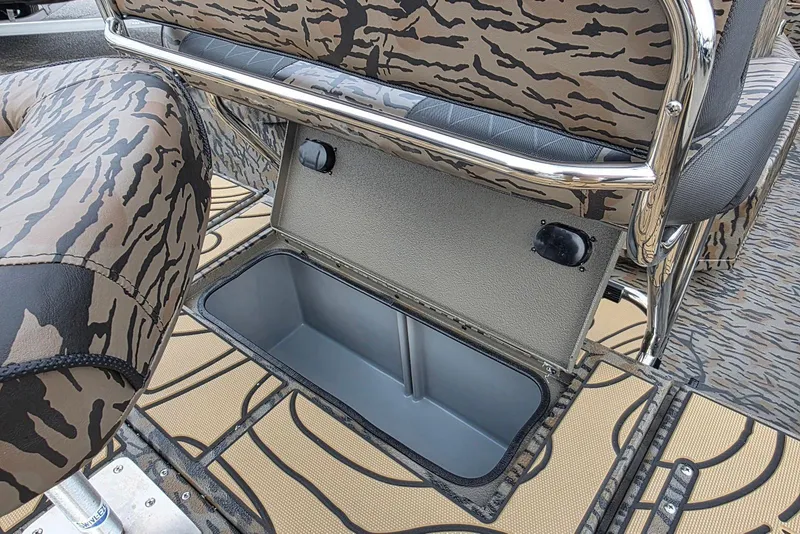 Slide: The Image of 2026 Xpress H20B Bay boat with open storage compartment and camouflage seating. - 46