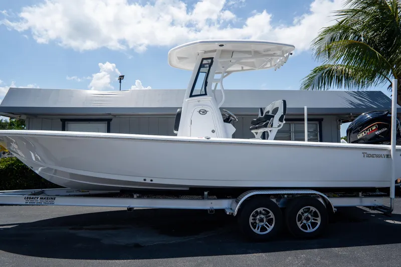 The Image of 2026 Tidewater 2410 Bay Max boat on trailer, parked outdoors under a sunny sky. - 0