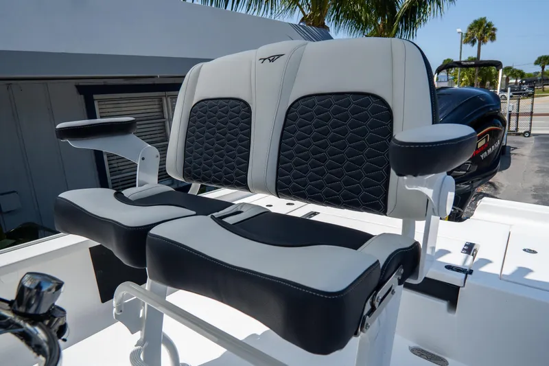 Slide: The Image of 2026 Tidewater 2410 Bay Max boat seating with black and white upholstery, featuring armrests. - 18