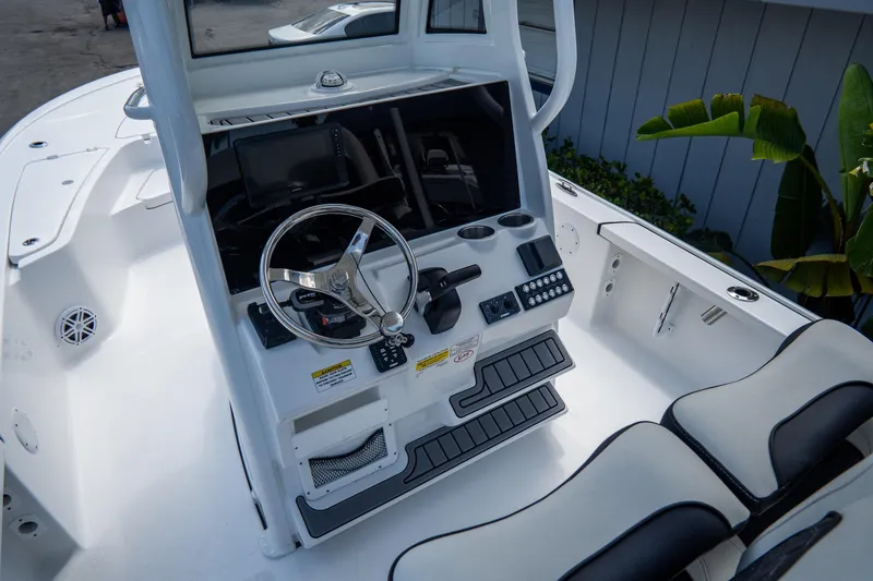 Slide: The Image of 2026 Tidewater 2410 Bay Max boat cockpit with steering wheel and control panel. - 20