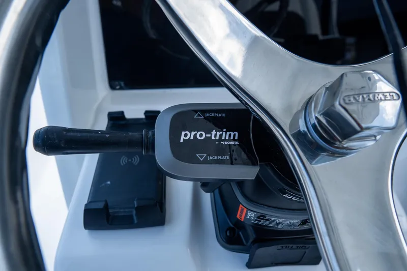 Slide: The Image of Close-up of 2026 Tidewater 2410 Bay Max boat steering wheel and pro-trim control. - 21