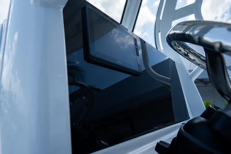 Slide: The Image of 2026 Tidewater 2410 Bay Max boat console with Garmin display and steering wheel. - 22