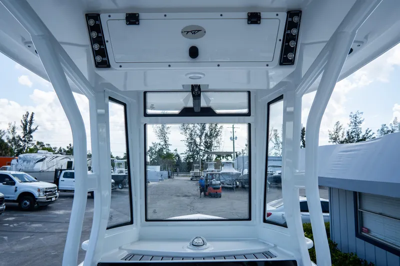 Slide: The Image of Tidewater 2410 Bay Max 2026 boat interior view with windows and control panel. - 25