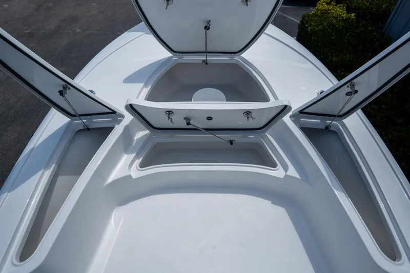 Slide: The Image of 2026 Tidewater 2410 Bay Max boat with open storage compartments on deck. - 30