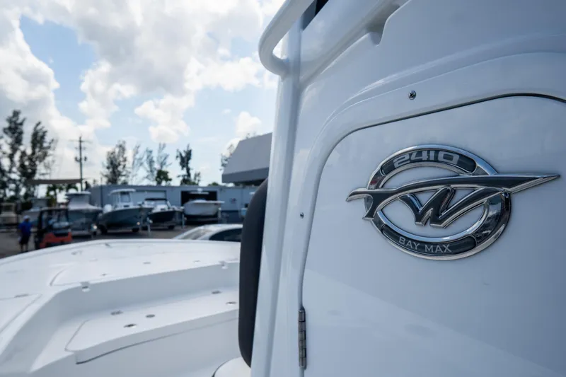 Slide: The Image of 2026 Tidewater 2410 Bay Max boat emblem with cloudy sky background. - 42