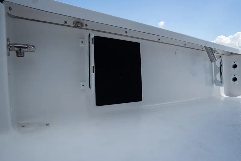 Slide: The Image of 2026 Tidewater 2410 Bay Max boat interior detail with storage compartment. - 44