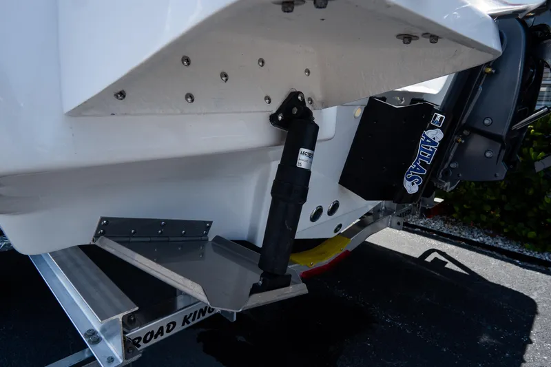 Slide: The Image of 2026 Tidewater 2410 Bay Max boat with hydraulic lift system and trailer. - 5