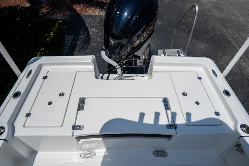 Slide: The Image of 2026 Tidewater 2410 Bay Max boat stern with outboard motor and storage compartments. - 8