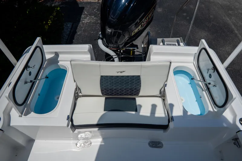 Slide: The Image of 2026 Tidewater 2410 Bay Max boat with open storage compartments and seating. - 9