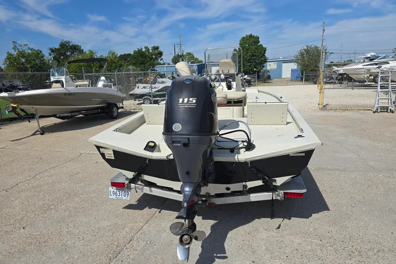 Slide: The Image of 2017 Xpress H20B Bay boat with 115 horsepower engine, parked in a marina. - 4