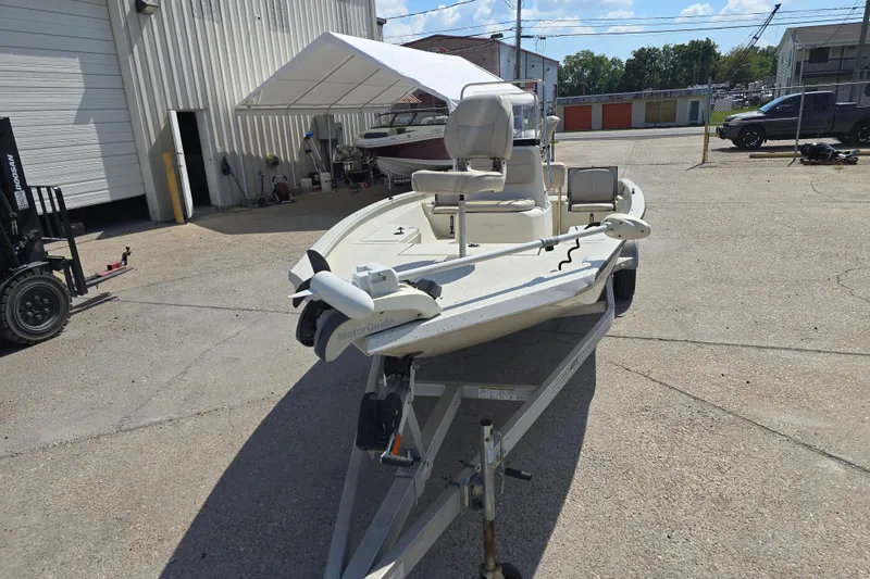 Slide: The Image of 2017 Xpress H20B Bay boat on trailer, parked outdoors near a building. - 8