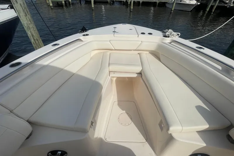 Slide: The Image of 2021 Grady-White Canyon 271 boat interior with spacious seating and sleek design at a dock. - 13