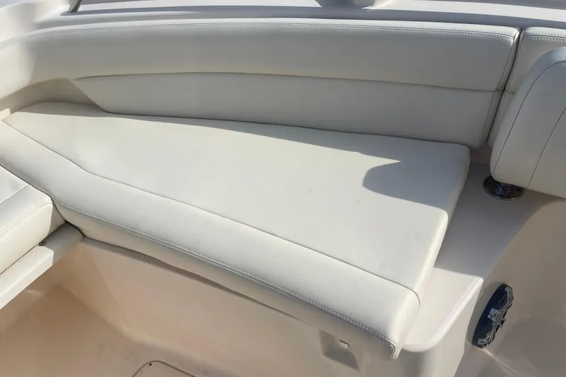Slide: The Image of 2021 Grady-White Canyon 271 boat interior with white cushioned seating. - 14